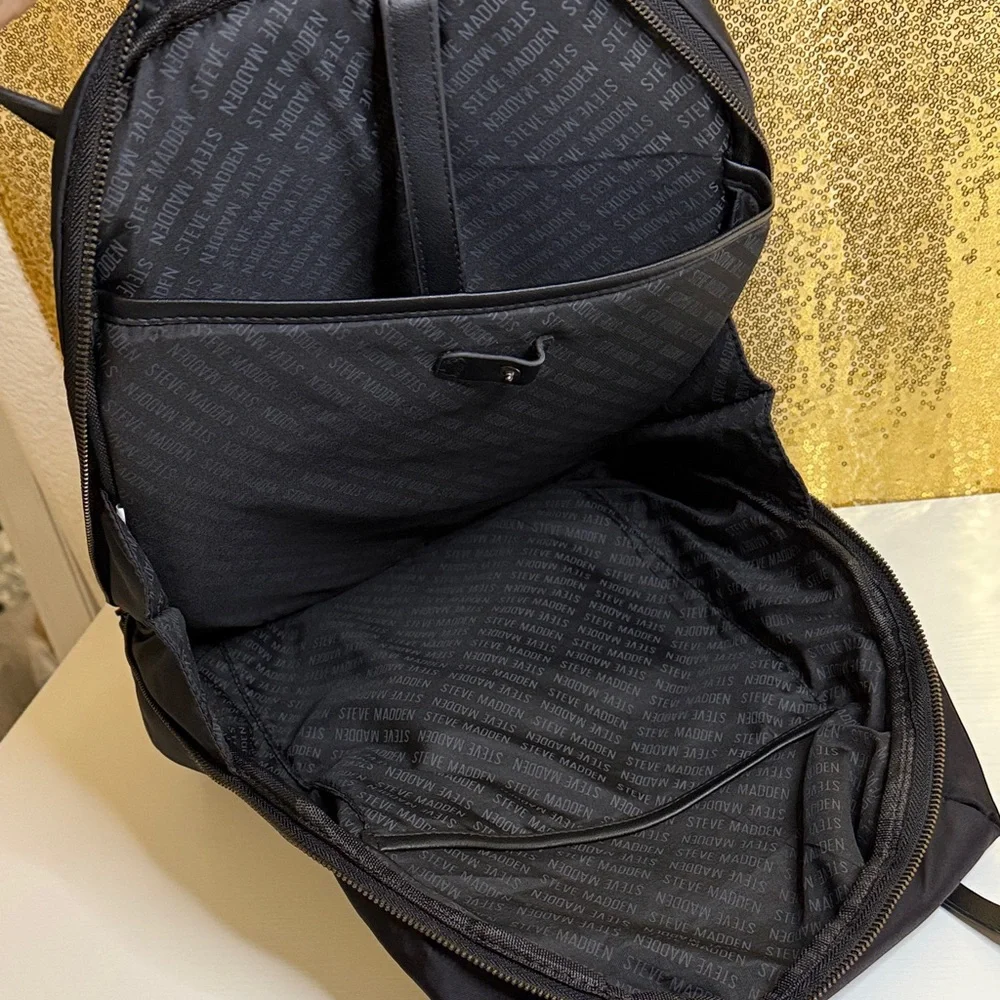 Steve Madden Bjodah Black Quilted Backpack with carry handles and branded strap